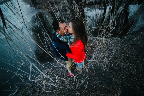 Bella coppia posa vicino a un fiume ghiacciato — Foto Stock