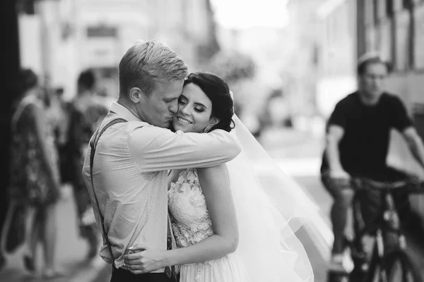 Groom hugs bride — Stock Photo, Image