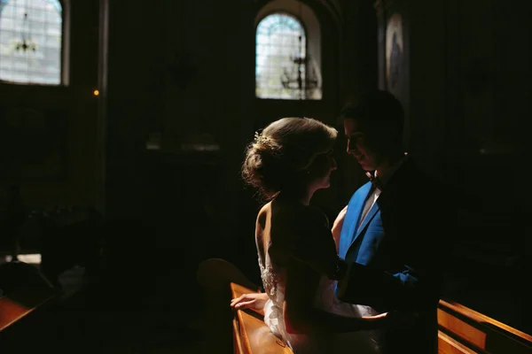 Bride and groom illuminated by light — Stock Photo, Image