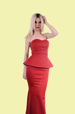 Beautiful fashion model stay in elegant pose, A sexy model in red dress is posing elastically, a cute model staying and looking down lovely