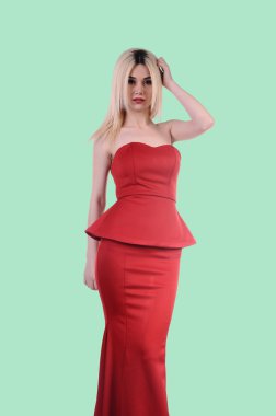 Beautiful fashion model stay in elegant pose, A sexy model in red dress is posing elastically, a cute model staying and looking down lovely