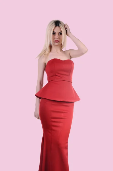 Beautiful fashion model stay in elegant pose, A sexy model in red dress is posing elastically, a cute model staying and looking down lovely