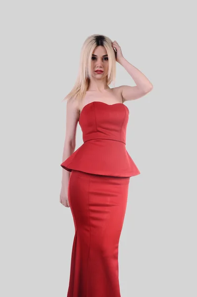 Beautiful fashion model stay in elegant pose, A sexy model in red dress is posing elastically, a cute model staying and looking down lovely