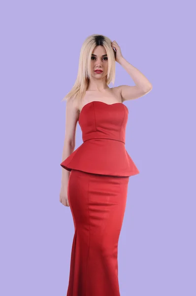 Beautiful fashion model stay in elegant pose, A sexy model in red dress is posing elastically, a cute model staying and looking down lovely