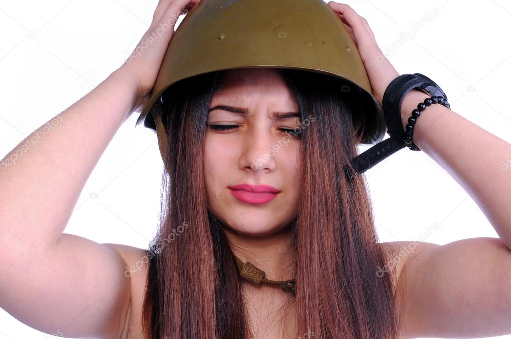 The soldier girl is holding her aching head