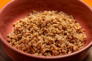 A portion of hydrated, textured soy protein in a crock pot.