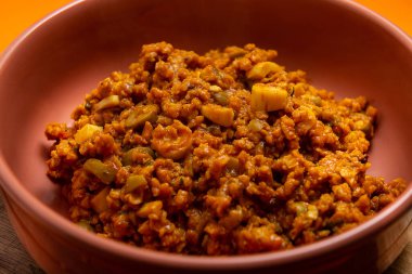 A serving of soy protein, seasoned and ready for consumption, in a bowl.