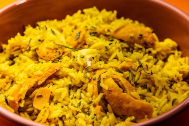 Rice with Brazilian Pequi. Detail of a crockery full of rice and pequi. Typical Brazilian food.