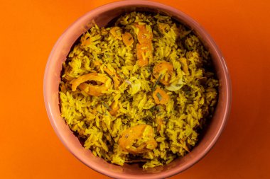 Rice with Brazilian Pequi. Detail of a crockery full of rice and pequi. Typical Brazilian food.