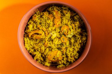 Rice with Brazilian Pequi. Detail of a crockery full of rice and pequi. Typical Brazilian food.