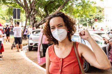 Gösteri sırasında maskeli bir kadın. Fotoğraf, Brezilya Başkanı Bolsonaro 'ya karşı yapılan bir protesto sırasında çekildi ve nüfusu aşılamak için aşı satın almada çeviklik talep ediliyor..