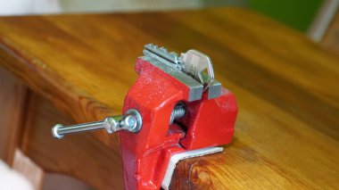 A person making a wrench and a nut with a rasp. Adjust the balance of the nut in the workshop. Repair worker.