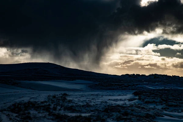 Dark storm clouds over snowy landscape Iceland abstract — Foto de Stock