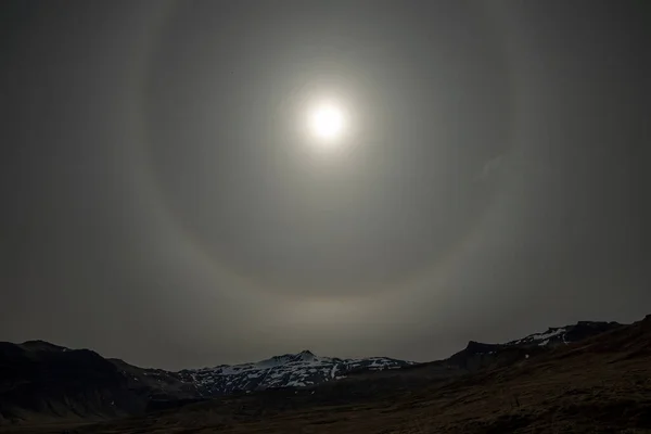 Sun halo over mountains in Iceland