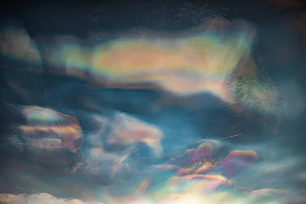Jet flying through colorful Nacreous clouds 스톡 이미지