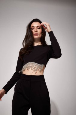 Güzel, genç, seksi iş kadını esmer, gece makyajlı, siyah takım elbiseli, ceketli, yüksek topuklu ayakkabılı, toplantı için giyinik, yürüyüş, vücut şekli mükemmel..