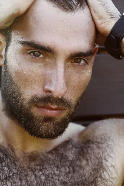 Fashion Portrait of handsome masculine guy with drop of water on face with Brown dark eyes Beard and mustache — Stock Photo, Image