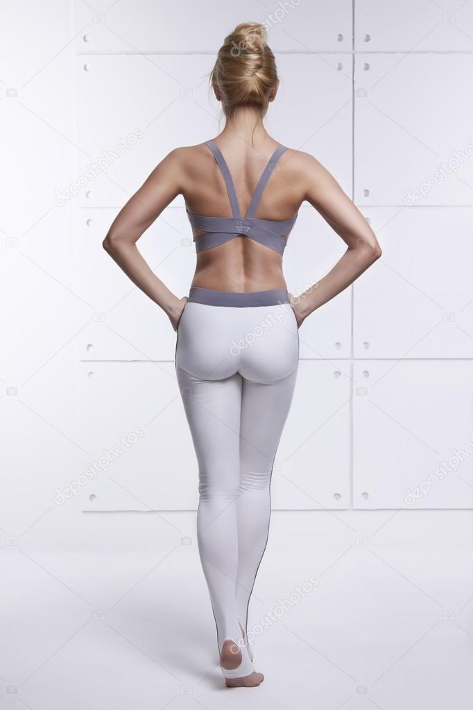 Beautiful sexy blonde with perfect athletic slim figure engaged in yoga, exercise or fitness, lead a healthy lifestyle, and eats right, dressed in comfortable casual clothes relaxes and meditation