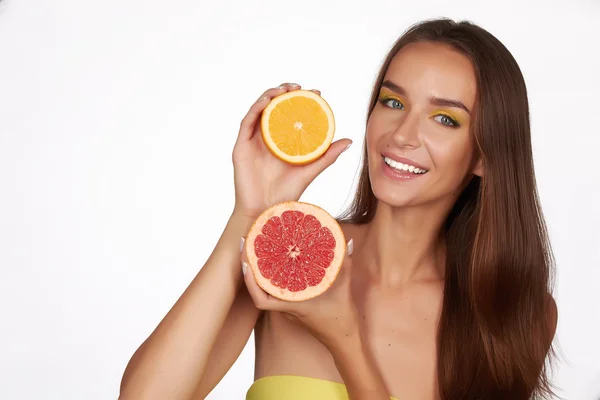 Beautiful sexy young woman with perfect healthy skin and long brown hair day makeup bare shoulders holding orange lemon grapefruit healthy eating organic food diet weight loss — Stock Photo, Image