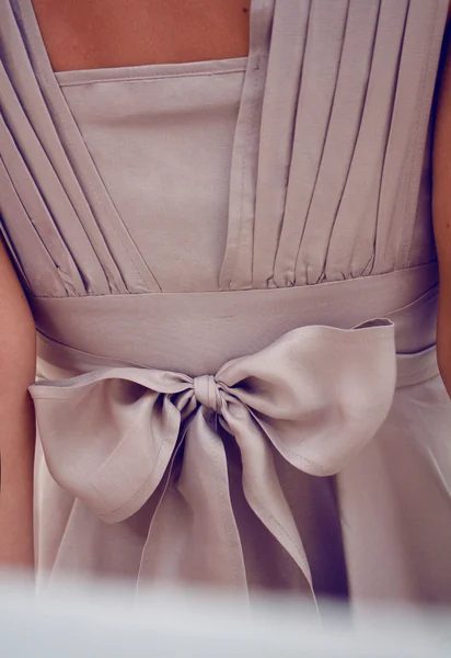 Detail on clothing or large silk chiffon bow on a beige dress — Stock Photo, Image