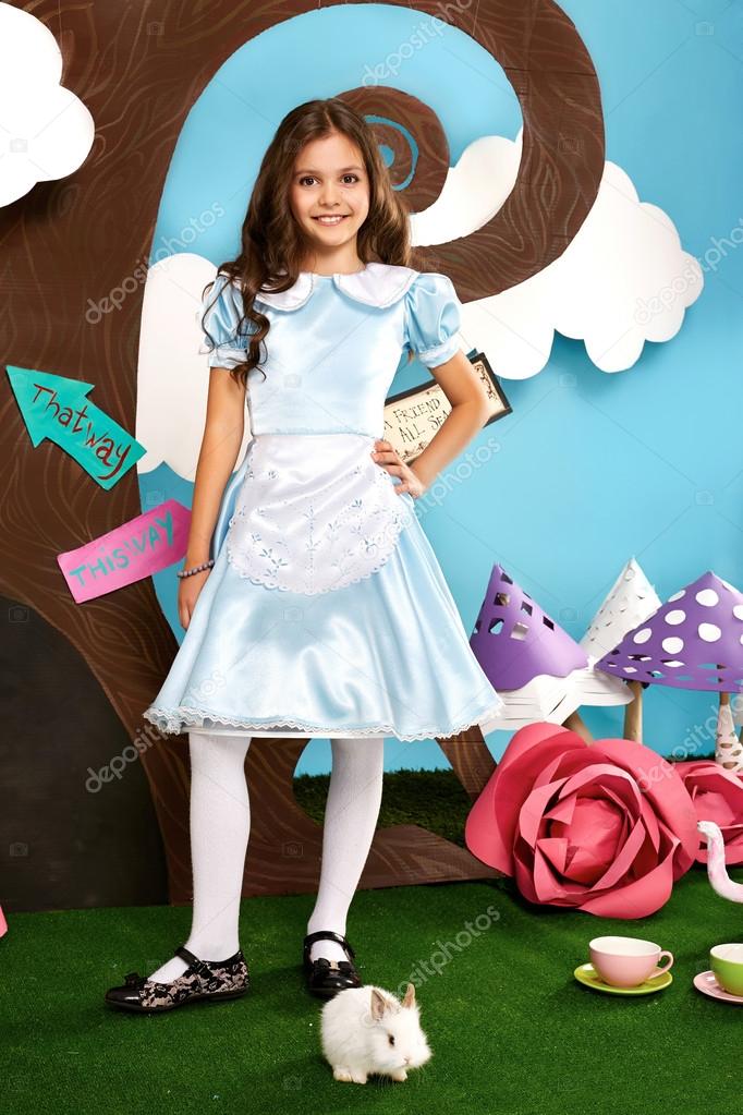 Beautiful little girl long hear blue dress with rabbit