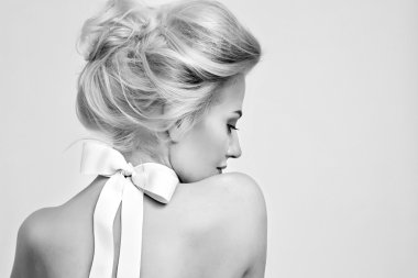 Beautiful gentle woman with silk bow on neck cosmetics body face