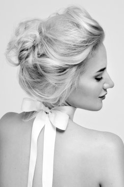 Beautiful gentle woman with silk bow on neck cosmetics body face
