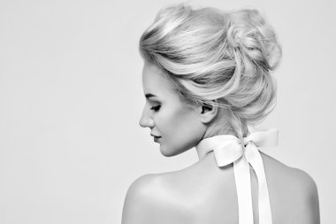 Beautiful gentle woman with silk bow on neck cosmetics body face