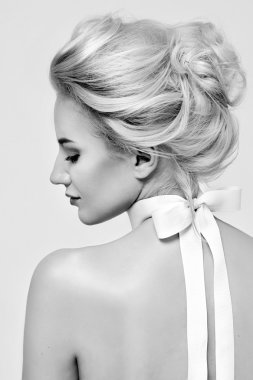 Beautiful gentle woman with silk bow on neck cosmetics body face