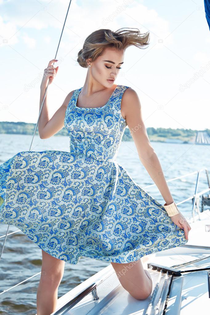 Beautiful sexy brunette girl in dress makeup summer trip yacht