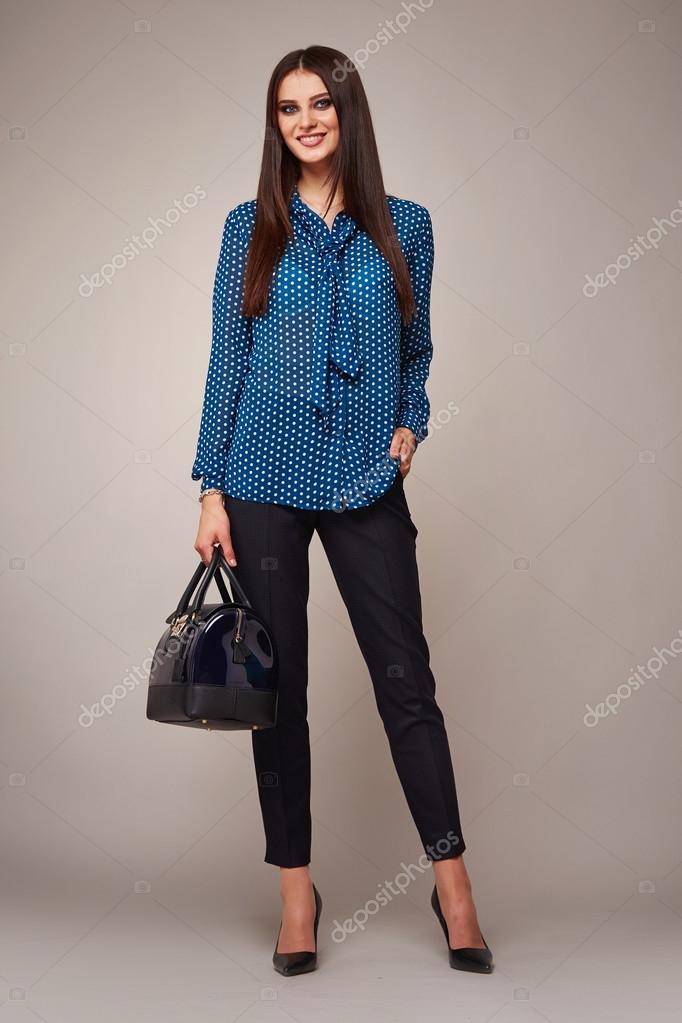 Young stylish brunette girl on shirt, pants and high heels shoes
