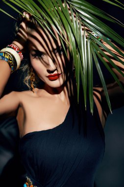 Beauty sexy woman makeup jungle palm sun tan shadows beach