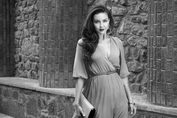 Beautiful sexy brunette woman walk silk dress party street — Stockfoto