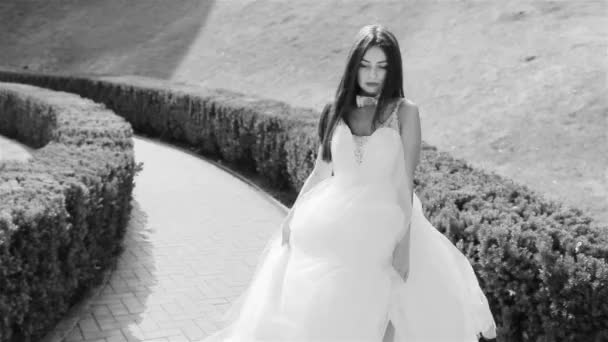 Beautiful young woman sexy brunette bride in a luxury white wedding dress the nature Castle Summer happiness awaits the groom before the wedding ceremony — Stock Video