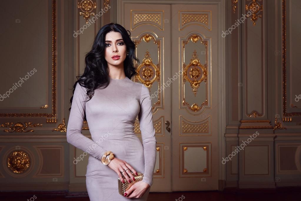 Beautiful sexy woman in elegant dress fashionable autumn Collection of  spring long brunette hair makeup tanned slim body figure accessories  interior luxury castle gold monogram baroque palace of Queen Stock Photo by  ©