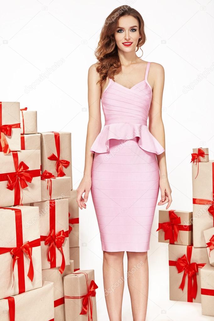 Beautiful young sexy woman thin slim figure evening makeup fashionable stylish dress, clothing collection, brunette, gifts boxes red silk bows holiday party birthday New Year Christmas Valentine's Day.