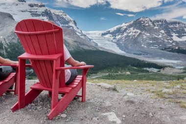 Behind View of Woman Sitting In Chair Enjoying the View clipart