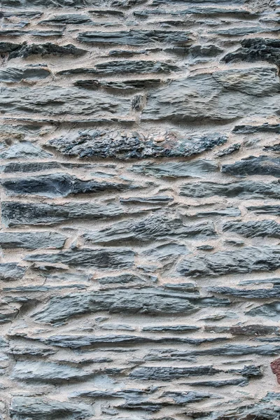Pietre grigie impilate con intonaco verticale — Foto Stock