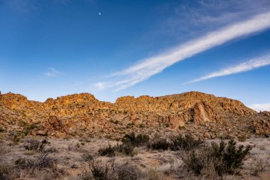 Clouds Streak The Blue Sky Over Grapevine Hills in Big Bend National Park clipart