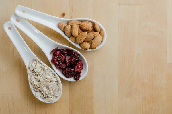 Spoons of Oats, Cranberries, and Almonds — Stock Photo, Image
