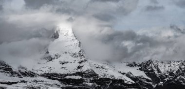 Bulutlar Duvarı, karanlık ve fırtınalı bir günde İsviçre Alplerinde Matterhorn 'u içine çekmeye başlıyor.