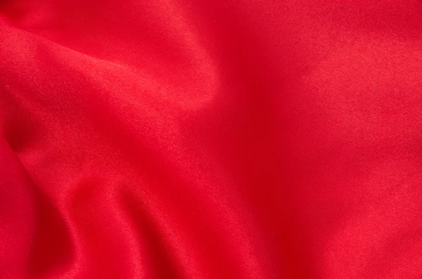 Κόκκινο σατέν ή μεταξωτό ύφασμα ως φόντο — Φωτογραφία Αρχείου