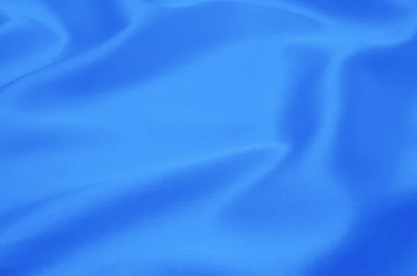 Blå satin eller silke tyg som bakgrund — Stockfoto