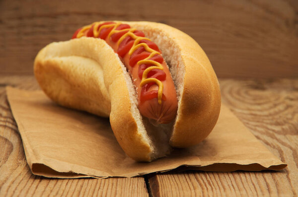 Вкусный хот-дог на деревянном столе