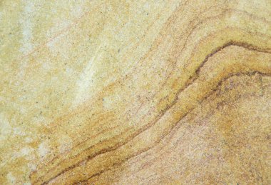 Kum taşından bir tuğlaya yakın, desenli bir arka plan.