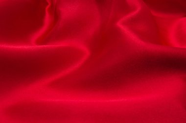 Arkaplan olarak kırmızı saten veya ipek kumaş