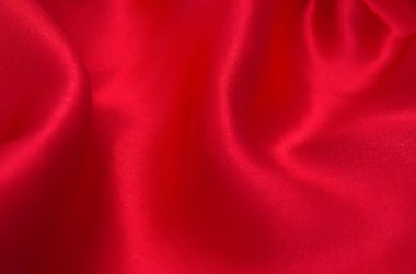 Arkaplan olarak kırmızı saten veya ipek kumaş