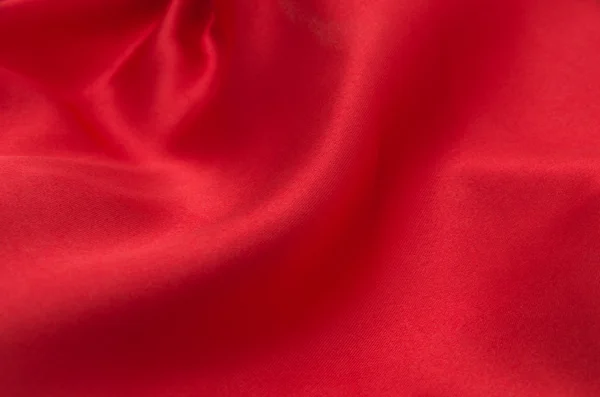 Czerwona satyna lub jedwab jako tło — Zdjęcie stockowe