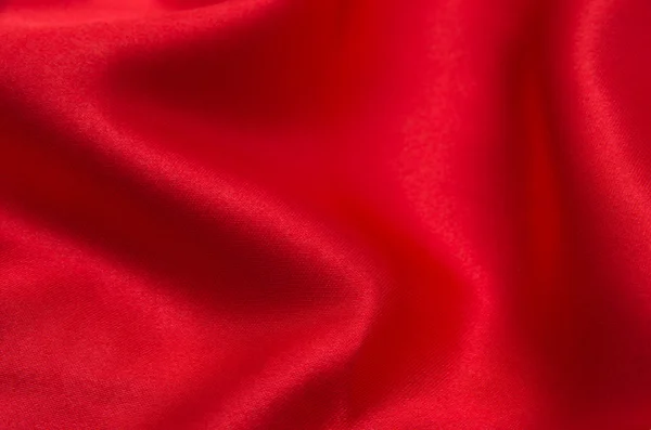 Red satin or silk fabric as background — Stock Photo, Image