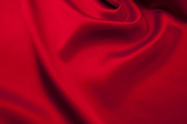 Arkaplan olarak kırmızı saten veya ipek kumaş